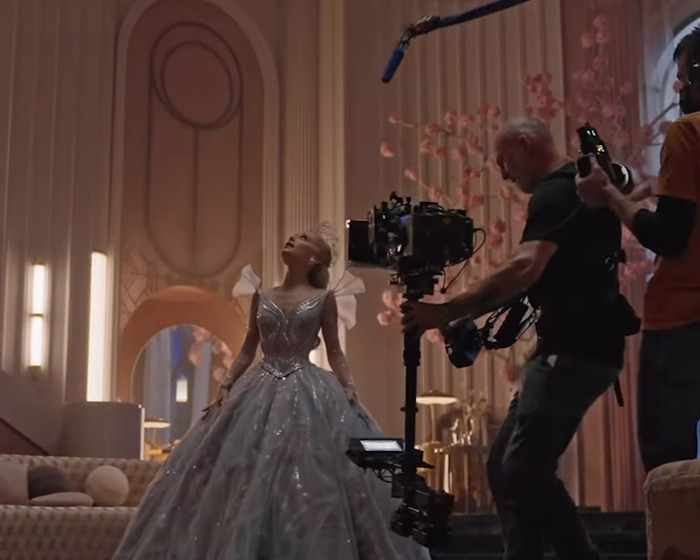 Ariana Grande filming a scene in an elegant gown with a camera crew capturing her cryptic last hurrah announcement. Ariana Grande filming a scene in an elegant gown with a camera crew capturing her cryptic last hurrah announcement.