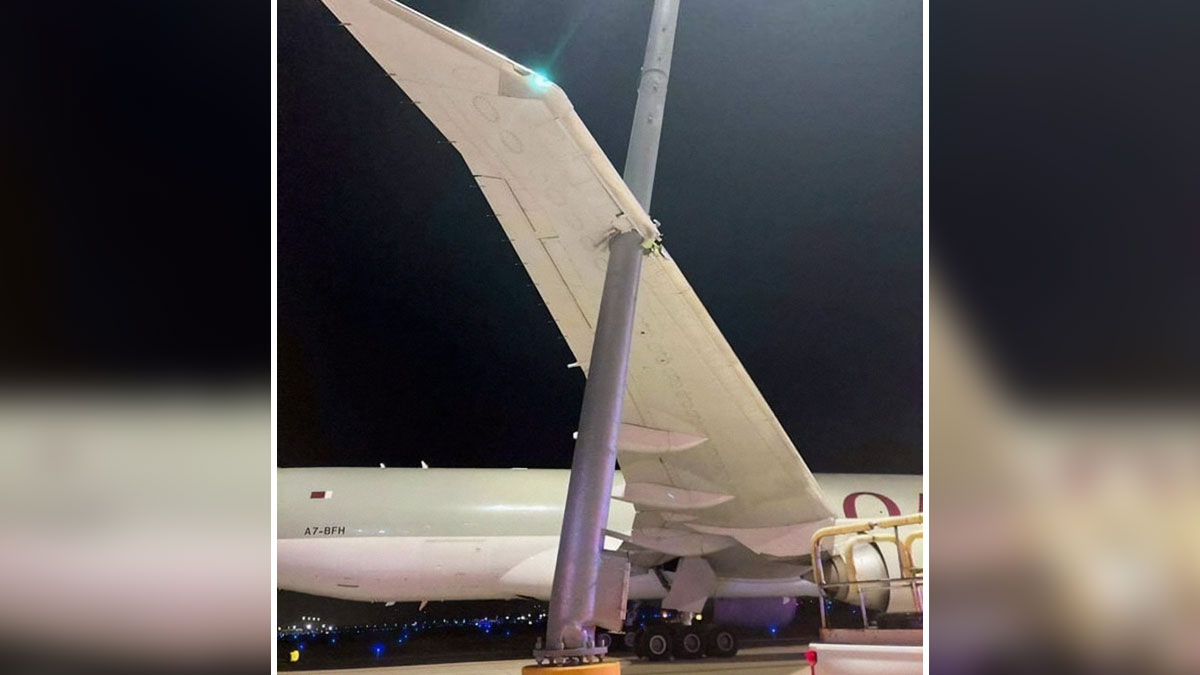Airplane wing humorously stuck on a runway light pole at night, illustrating aviation memes for frequent flyers.