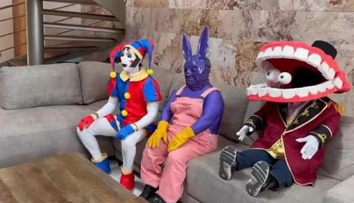 Three unhinged behind-the-scenes photos feature people in colorful, bizarre costumes sitting on a couch indoors.