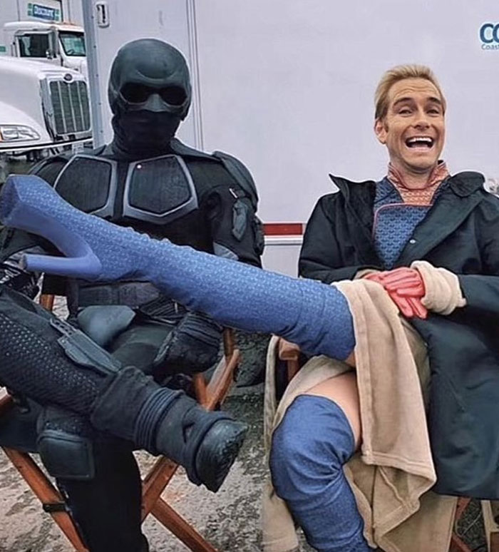 Two actors in costume sharing a funny unhinged behind-the-scenes moment during filming, meme-worthy photo.