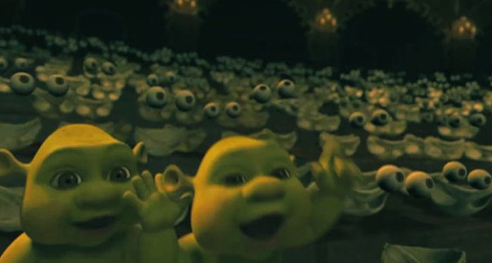 Unhinged behind-the-scenes photo showing numerous animated characters making funny faces in a dark, crowded setting.