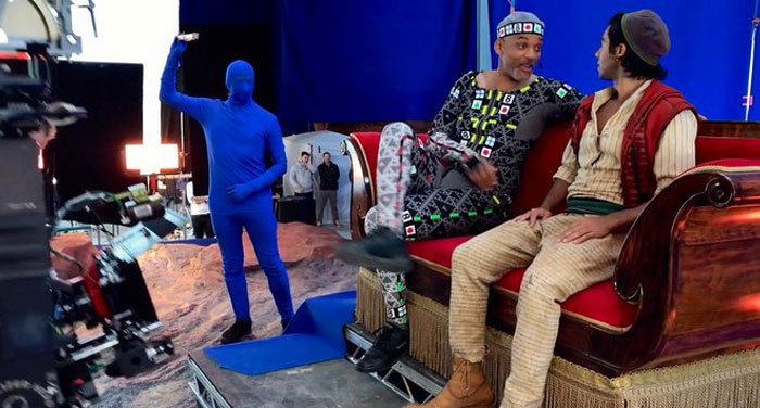 Behind-the-scenes photo showing actors in costume and crew in motion capture suits on a film set ready for unhinged moments.