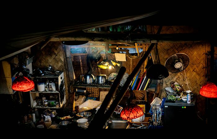 Dimly lit cluttered kitchen showing surprising habits people discovered about their partner after moving in with them.