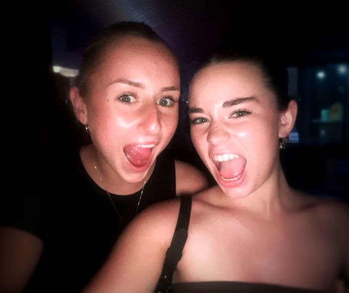 Two young women smiling widely in a dark setting, related to parents warning against travel after daughters' deaths. Two young women smiling widely in a dark setting, related to parents warning against travel after daughters' deaths.