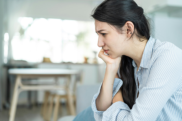 Young woman looking worried and thoughtful indoors, reflecting on boyfriend's demand about marriage and home renovation finance. Young woman looking worried and thoughtful indoors, reflecting on boyfriend's demand about marriage and home renovation finance.