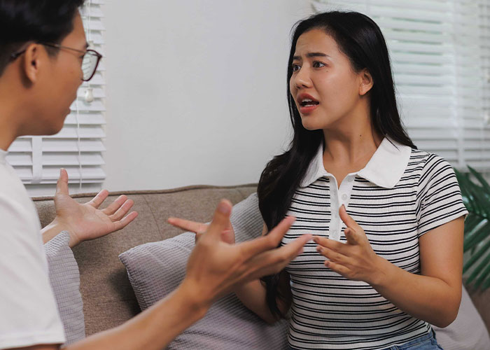 Woman and man having a serious conversation at home, depicting conflict related to her success and new life choices. Woman and man having a serious conversation at home, depicting conflict related to her success and new life choices.