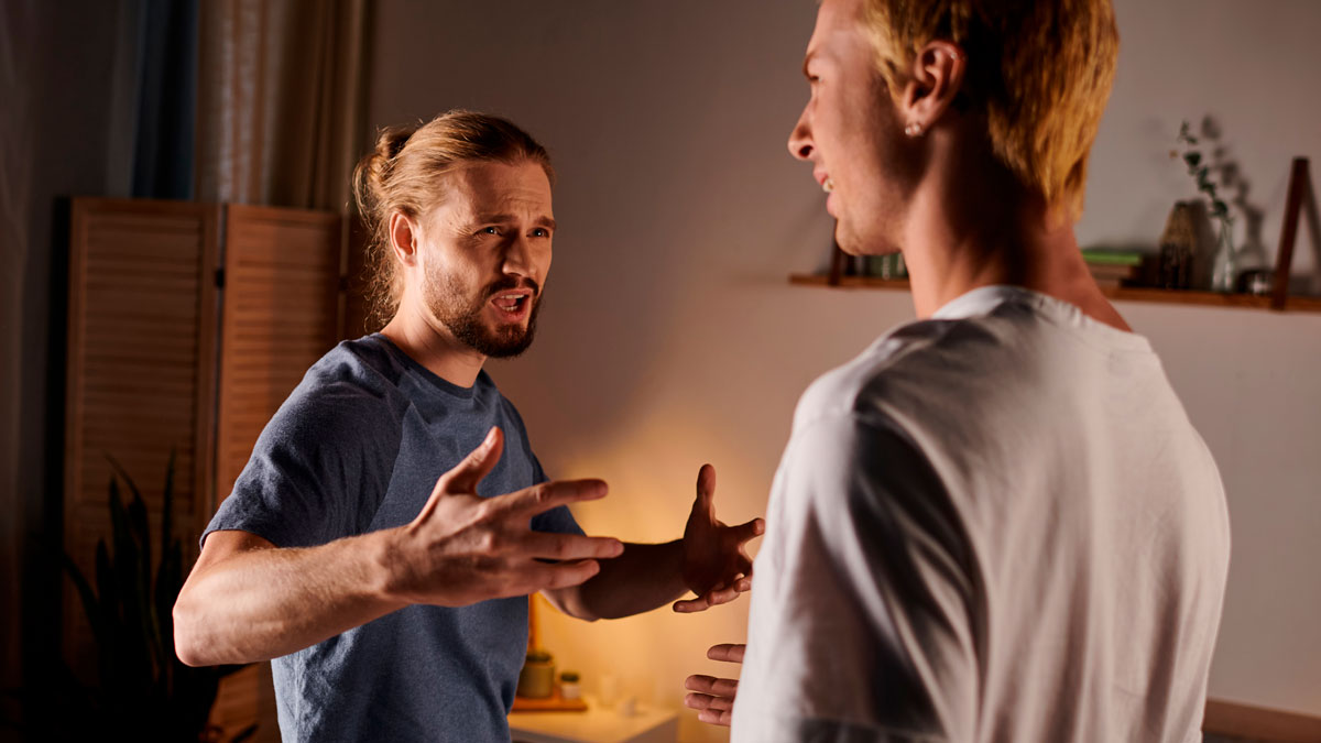 Two men arguing indoors with tense expressions, illustrating conflict involving brideu2019s family and fiancu00e9 threats.