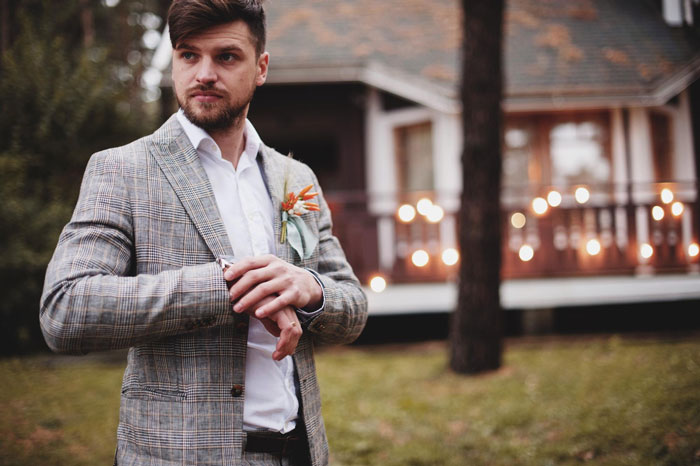 Young man adjusting jacket outdoors near house, depicting brother uses sister’s credit card without permission concept Young man adjusting jacket outdoors near house, depicting brother uses sister’s credit card without permission concept