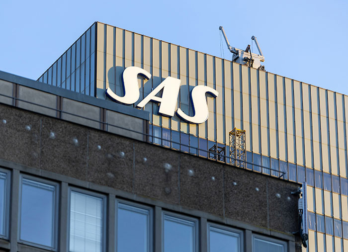 SAS building exterior with logo against clear sky, illustrating unexpected stories of a bad day turning life-changing.