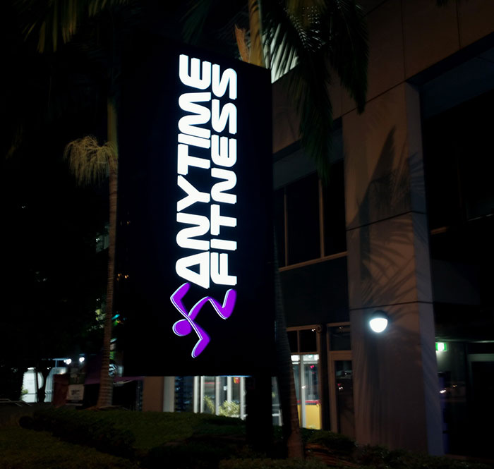 Anytime Fitness illuminated sign at night outside a building representing businesses that lost clients with poor decisions