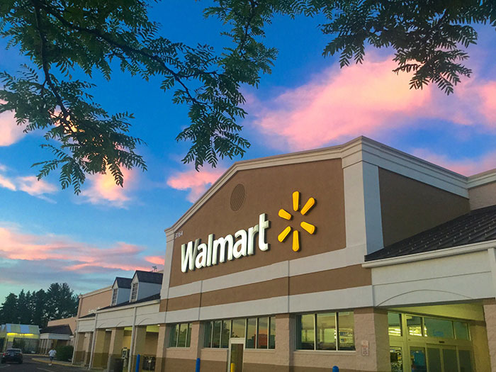 Walmart storefront at sunset with colorful sky, representing businesses that lost clients with poor decisions.