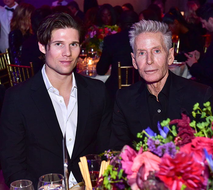 Calvin Klein, 83, and his boyfriend, 36, dressed formally at a crowded event with floral table decorations. Calvin Klein, 83, and his boyfriend, 36, dressed formally at a crowded event with floral table decorations.