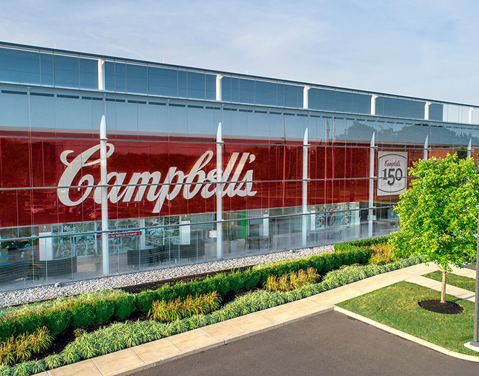 Campbell's building exterior with large logo, related to leaked audio exposing disturbing comments about soup ingredients. Campbell's building exterior with large logo, related to leaked audio exposing disturbing comments about soup ingredients.