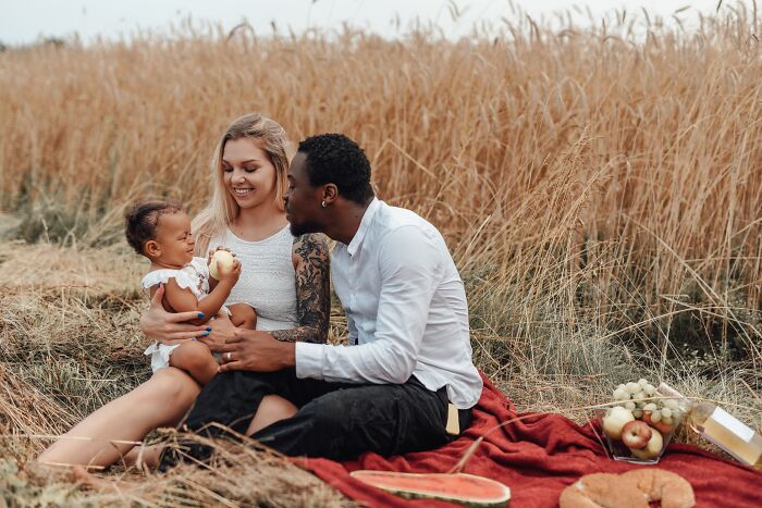 Family enjoying a picnic in a field, highlighting internet rabbit holes that took over people's lives.