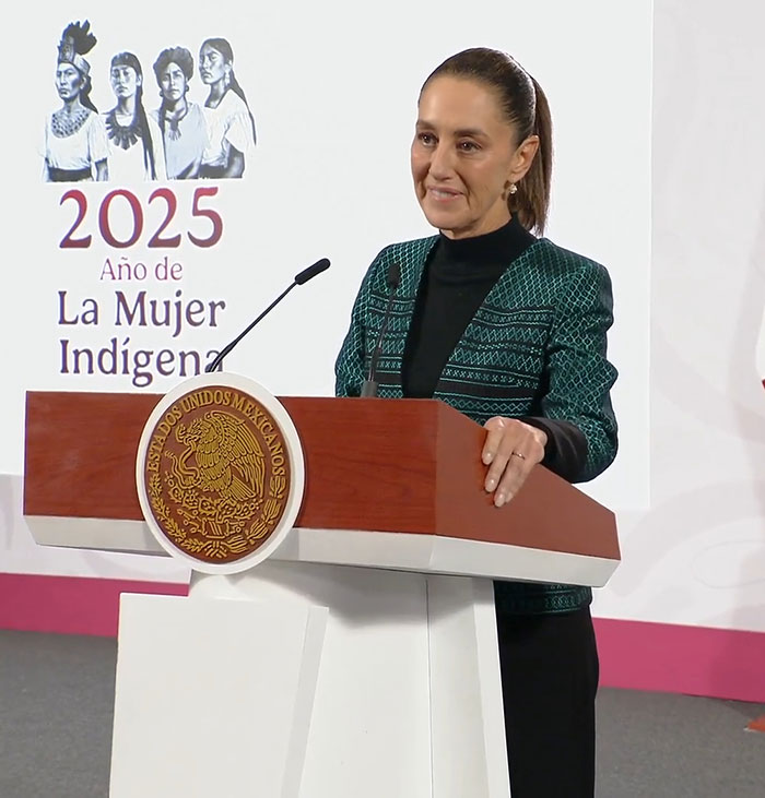 Mexican president speaking at podium during event on indigenous women in 2025 with emblem of Estados Unidos Mexicanos visible. Mexican president speaking at podium during event on indigenous women in 2025 with emblem of Estados Unidos Mexicanos visible.