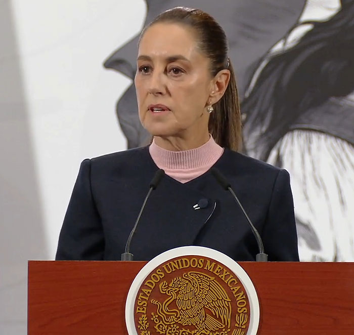 Female Mexican president speaking at podium with seal, highlighting reality for a lot of women in leadership roles Female Mexican president speaking at podium with seal, highlighting reality for a lot of women in leadership roles