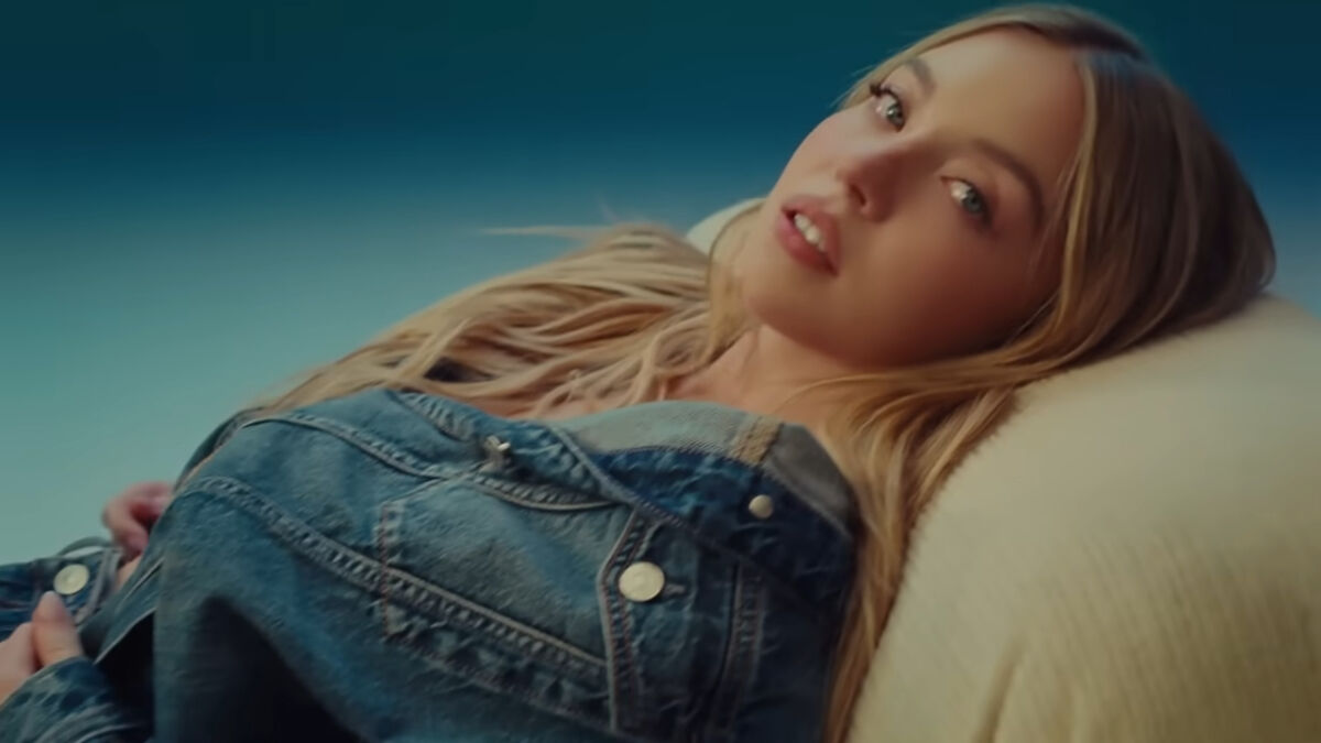 Young woman in a denim jacket reclining on a cushion, representing times brands went too far with their ads.