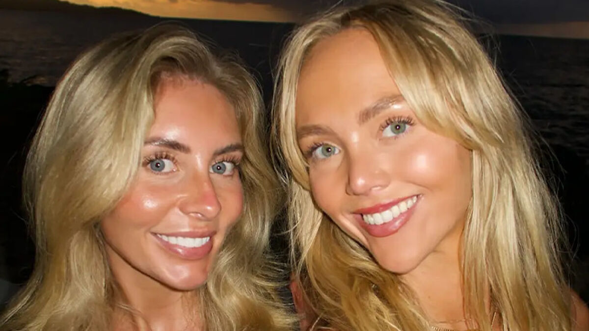 Two blonde women smiling at sunset with ocean background, related to adult performer controversy with 18YO students.