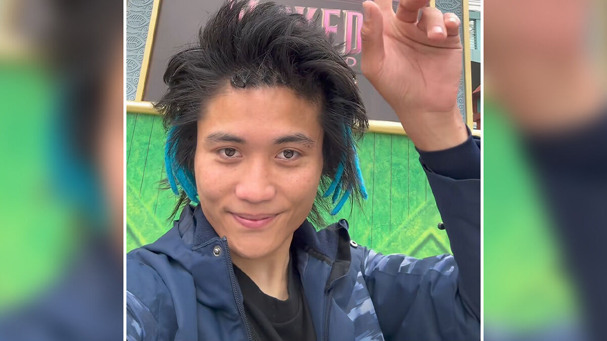 Young man with blue streaks in hair, wearing a blue jacket, outing himself as fan who attacked Ariana Grande at premiere online.