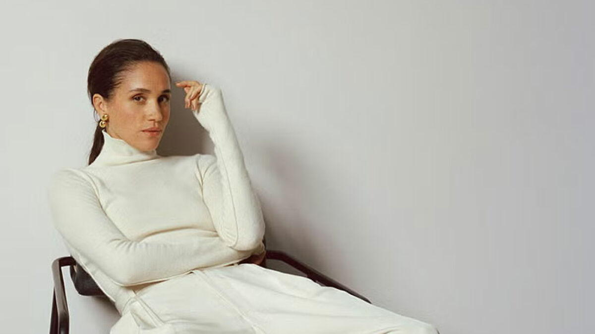 Meghan Markle posing in a white turtleneck and trousers for a Harperu2019s Bazaar moment, creating an internet buzz.