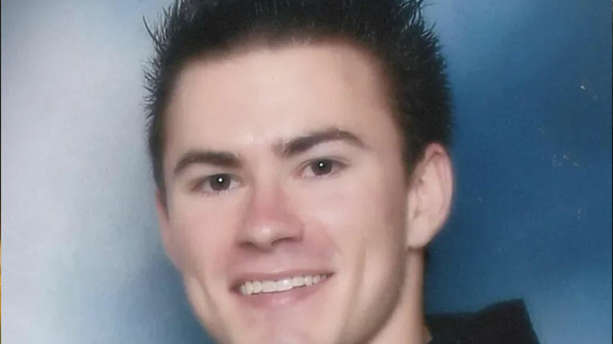 Young man smiling in a close-up portrait, related to the story about skinned body display in Las Vegas museum.