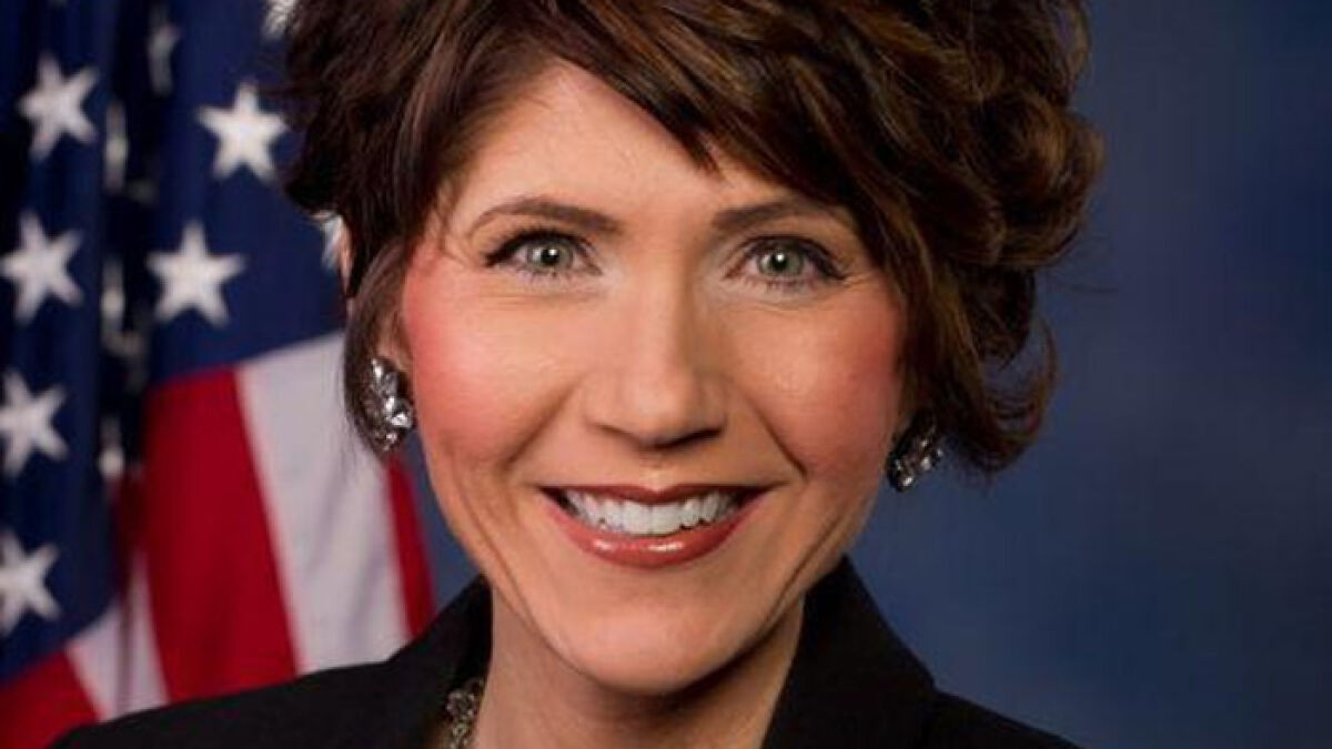 Kristi Noem smiling in a formal portrait with an American flag background showing her transformation over the years