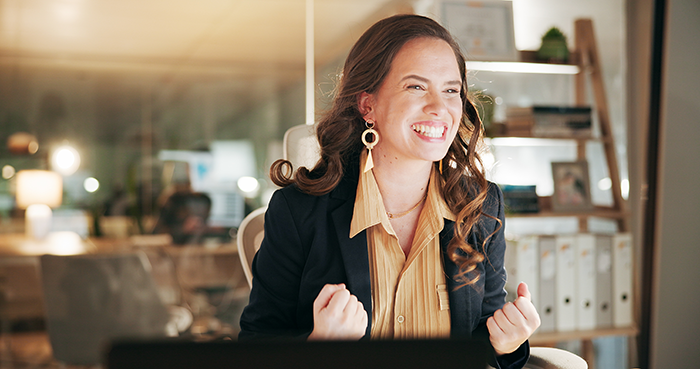 Woman in an office celebrating confidently after an office swap, highlighting employee frustration and coworker conflict. Woman in an office celebrating confidently after an office swap, highlighting employee frustration and coworker conflict.