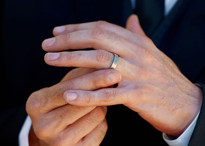 Close-up of hands with a silver ring, illustrating a moment from weird and crazy ER stories in a medical setting.
