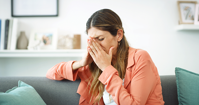 Woman feeling guilty after discovering boyfriend cheating, sitting on couch covering her face with hand at home. Woman feeling guilty after discovering boyfriend cheating, sitting on couch covering her face with hand at home.
