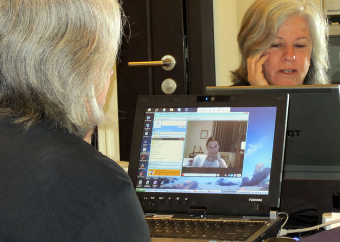 Woman in video call on laptop reflecting on corporate failures with 70 companies competing for corporate darwin award.