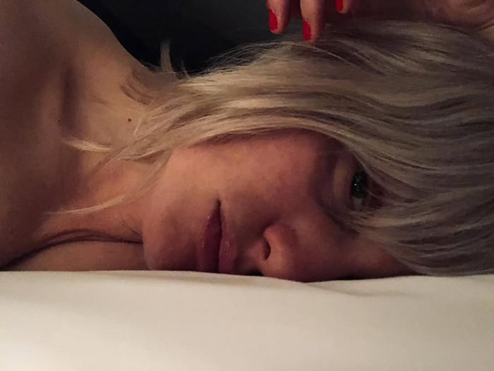 Alison Sudol lying down with blonde hair, showing a contemplative expression in a dimly lit setting. Alison Sudol lying down with blonde hair, showing a contemplative expression in a dimly lit setting.