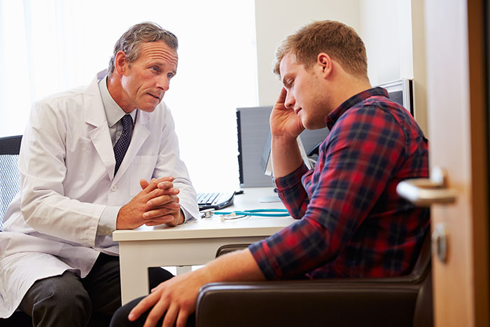 Doctor and patient in a consultation, showing concern and discussion about medical errors and doctor mistakes.