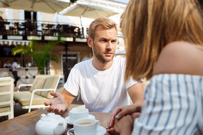 Couple having a serious discussion outdoors, highlighting concerns about negligent dog owners and dog bite incidents. Couple having a serious discussion outdoors, highlighting concerns about negligent dog owners and dog bite incidents.
