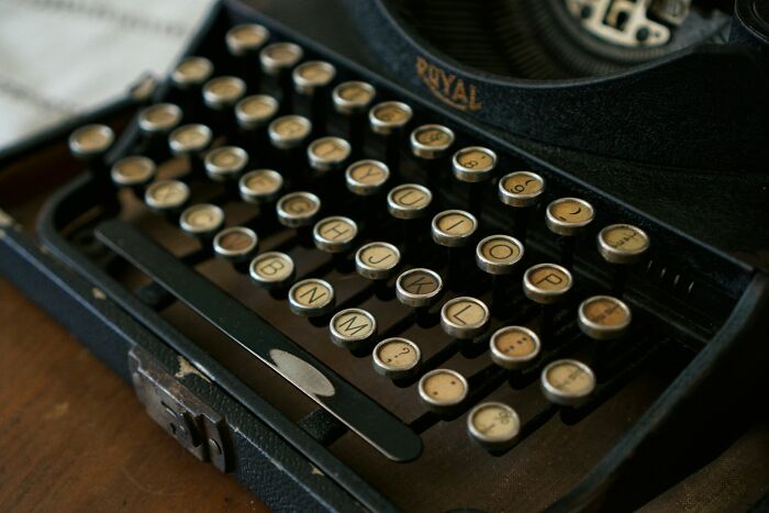 Close-up of an old Royal typewriter keyboard keys, vintage work secrets from barista to plumber revealed.