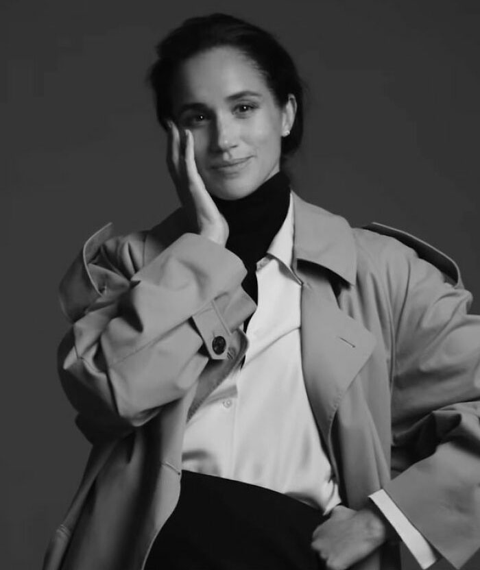Meghan Markle makeup-free portrait showing natural expression with hand on cheek in black and white cover photo session. Meghan Markle makeup-free portrait showing natural expression with hand on cheek in black and white cover photo session.