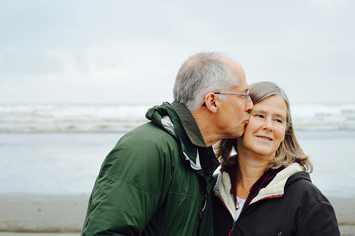 Older couple by the beach with man kissing woman on cheek, reflecting future daughter-in-law demands and wealthy in-laws prenup. Older couple by the beach with man kissing woman on cheek, reflecting future daughter-in-law demands and wealthy in-laws prenup.