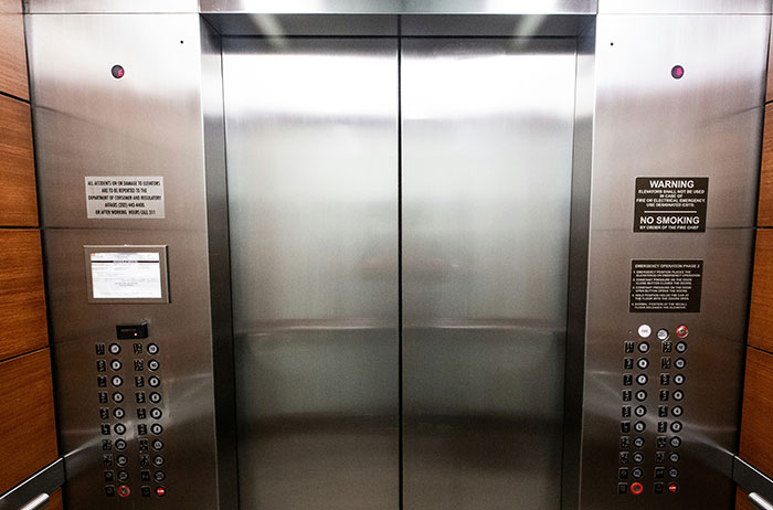 Elevator interior with metal doors and control panels, symbolizing unexpected lives that ended in surprising ways.