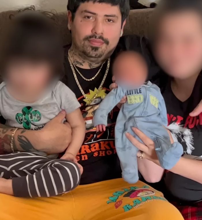 Man holding children indoors with woman, related to woman found chained in backyard in bizarre case story. Man holding children indoors with woman, related to woman found chained in backyard in bizarre case story.