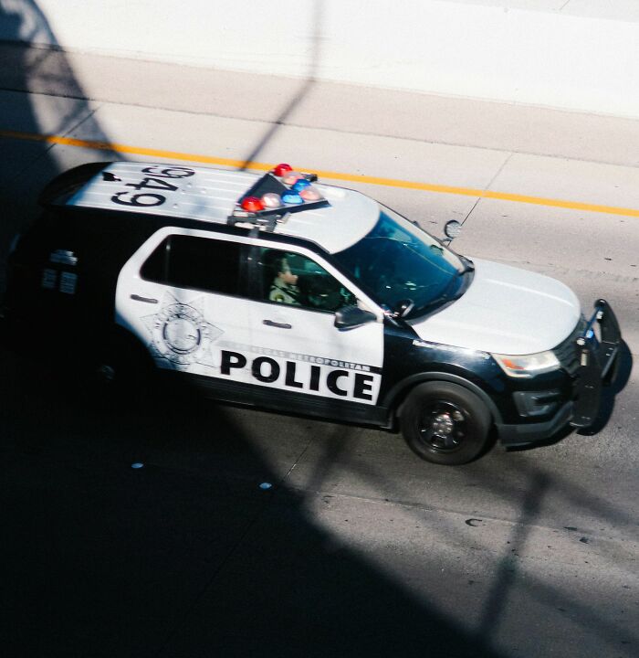Police car parked on street during investigation of woman found chained in backyard in bizarre case. Police car parked on street during investigation of woman found chained in backyard in bizarre case.
