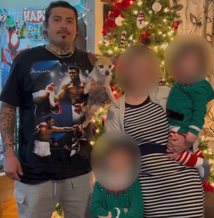 Family standing by decorated Christmas tree with blurred faces, unrelated to woman found chained in backyard SEO keywords. Family standing by decorated Christmas tree with blurred faces, unrelated to woman found chained in backyard SEO keywords.