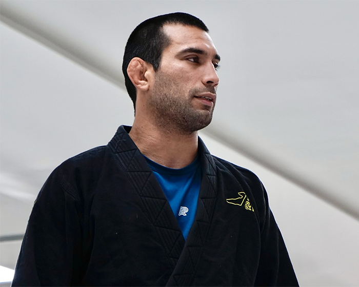 Jiu-Jitsu trainer in black gi looking to the side after tragic freak accident during sparring session Jiu-Jitsu trainer in black gi looking to the side after tragic freak accident during sparring session