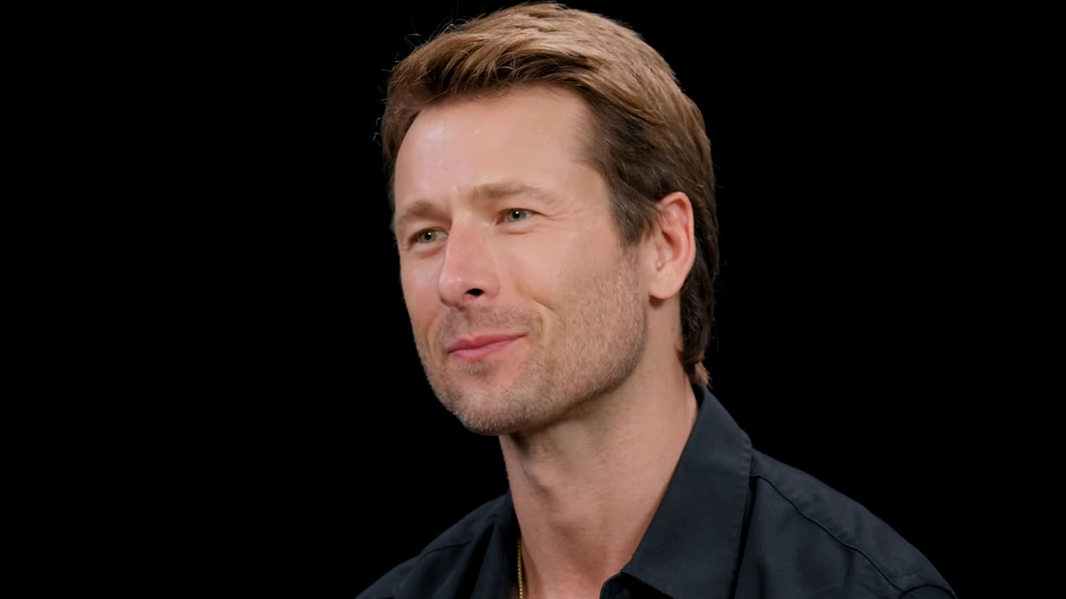Glen Powell in a close-up interview setting, highlighting a viral blunder and dark side of Hollywood discussion.