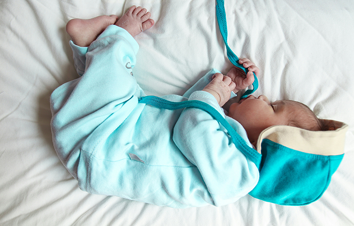 Newborn baby lying on a white bed wearing a blue outfit, symbolizing themes of pregnancy and postpartum challenges. Newborn baby lying on a white bed wearing a blue outfit, symbolizing themes of pregnancy and postpartum challenges.