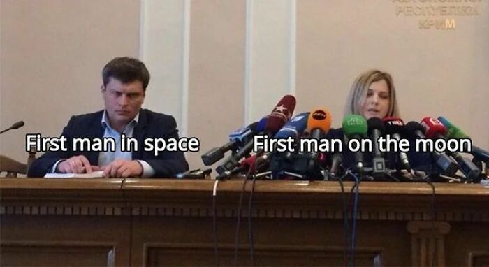 Two people at a press conference humorously labeled as first man in space and first man on the moon, history memes content.