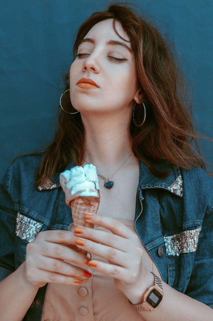 Young woman with closed eyes holding melting ice cream cone, reflecting on insensitive things said to people having a hard time.