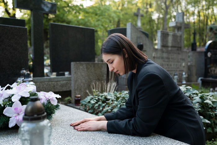 Woman dressed in black at a gravesite, reflecting on obsession mistaken for pregnancy as a life-threatening condition sign. Woman dressed in black at a gravesite, reflecting on obsession mistaken for pregnancy as a life-threatening condition sign.