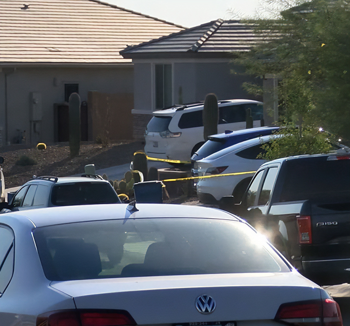 Residential street with multiple parked cars and police tape, related to dad fatally leaving 2YO daughter in car case. Residential street with multiple parked cars and police tape, related to dad fatally leaving 2YO daughter in car case.