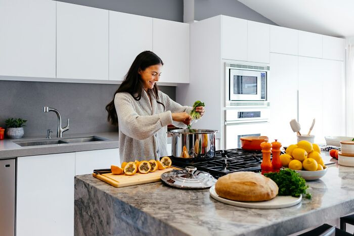 Home cook preparing vegetables in a modern kitchen emphasizing the importance of sharpening your knives for cooking success.