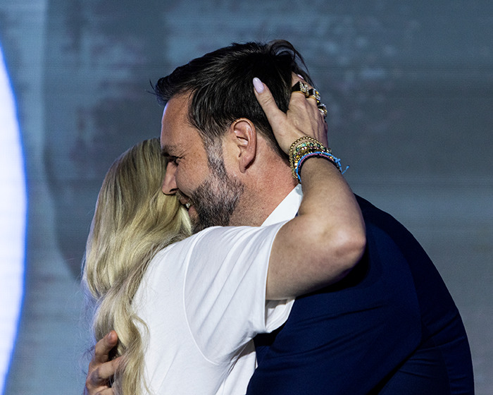 JD Kirk and Usha Vance embracing during an event, addressing rumors sparked by a ringless photo online. JD Kirk and Usha Vance embracing during an event, addressing rumors sparked by a ringless photo online.