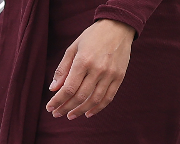 Close-up of a hand without a ring, wearing a dark red sleeve, sparking JD Kirk and Usha Vance split rumors online.